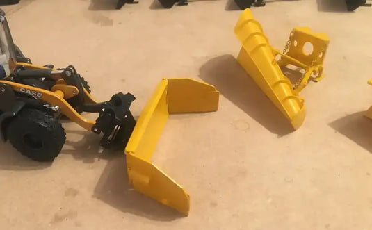 Yellow construction equipment attachment or scoop piece.